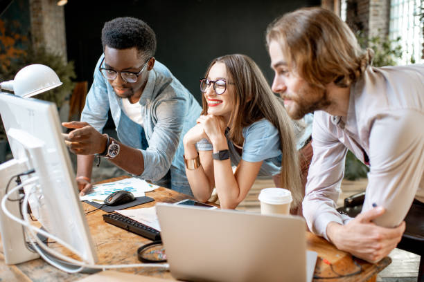 istock Young coworkers working with computer indoors 1075598938