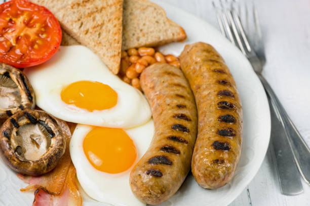 istock Classic full English breakfast served on white table. Close view. 1075599340