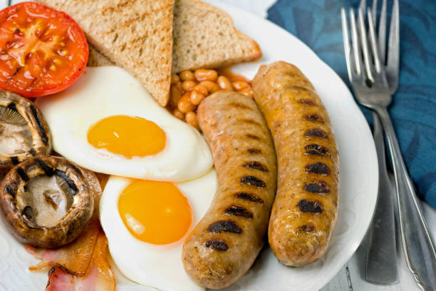 istock Classic full English breakfast served on white table. Close view. 1075599390