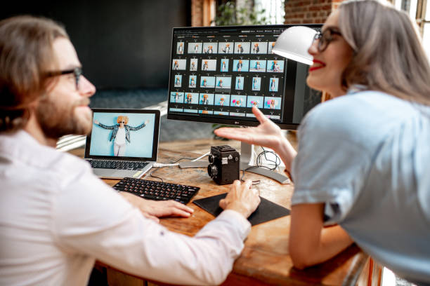 istock Couple of photographers working on computers in the studio 1075600266