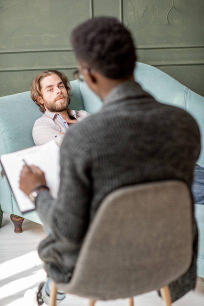 istock Man during a psychological session with psychologist 1075609252