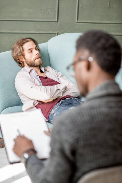 istock Man during a psychological session with psychologist 1075609280