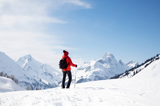 istock Female backpacker admires the winter mountain view 1075610010