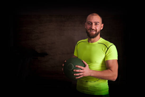 istock Fit and Happy Young Man Holding an Exercise Ball 1075623092