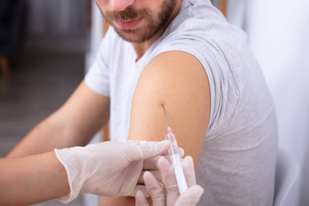 istock Doctor Injecting Patient With Syringe 1075627388