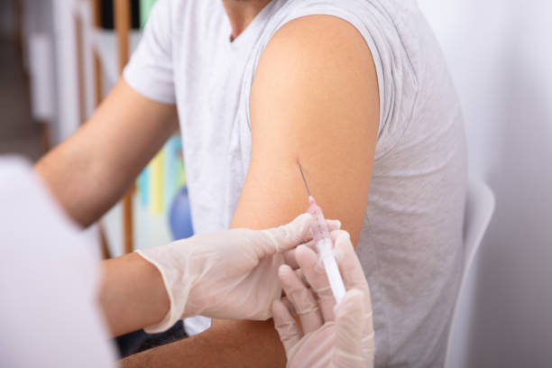 istock Doctor Injecting Patient With Syringe 1075627394