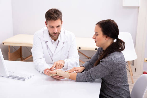 istock Orthopedist Fixing Plaster On Injured Woman's Hand 1075627456