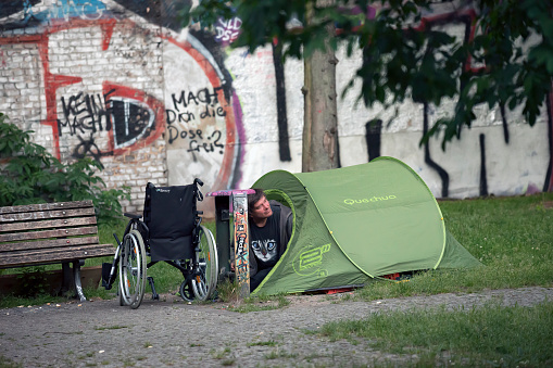 Homeless man with wheelcahair and tent in Berlin