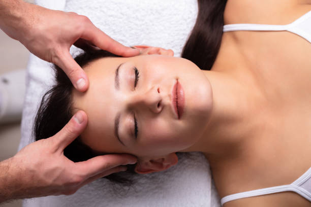 istock Therapist Massaging Woman's Head 1075627784