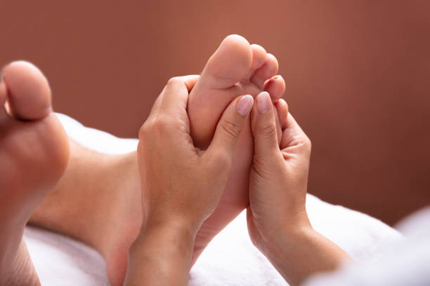 istock Therapist Giving Foot Massage To Man 1075627822