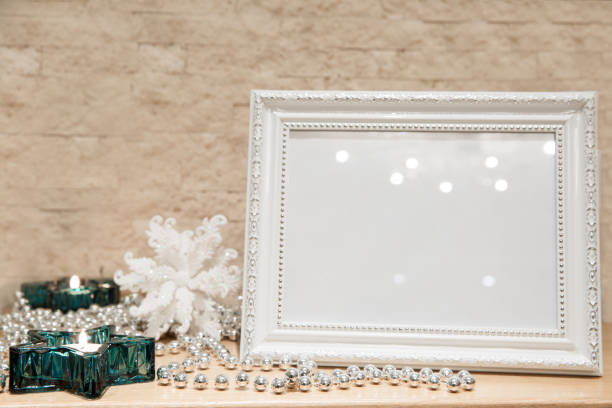 istock Mock up christmas decoration. New Year greeting frame. Turquoise stars-shaped candlesticks, glitering silver glass beads, snowflake background. Brick walls, copy space. 1075630138