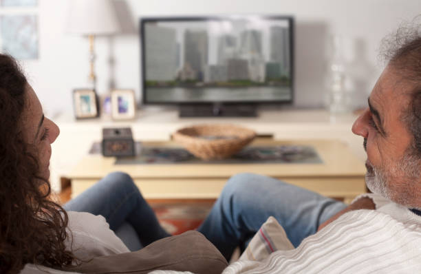 istock happy middle aged couple watching tv 1075639678
