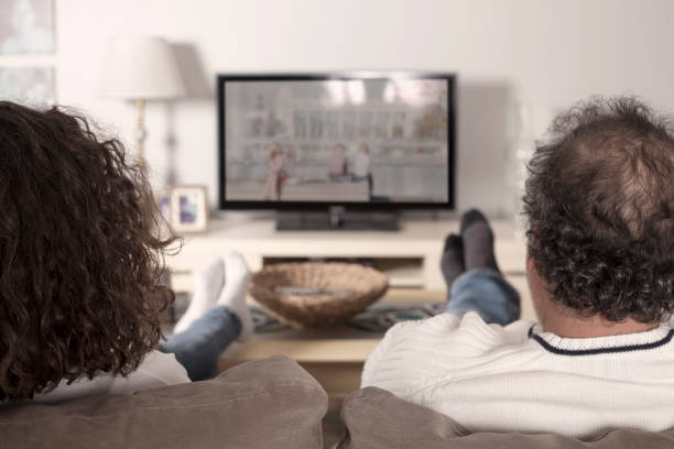 istock happy middle aged couple watching tv 1075639712