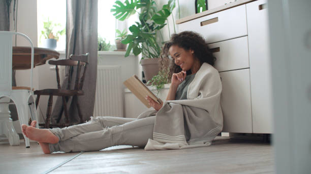 istock Pretty young woman using digital tablet in cozy kitchen. 1075643088