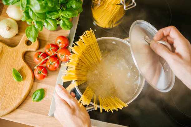 istock Man cooking pasta in pot 1075657522