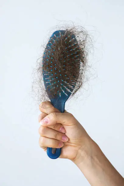 Photo of Hairbrush with a lot of female hair