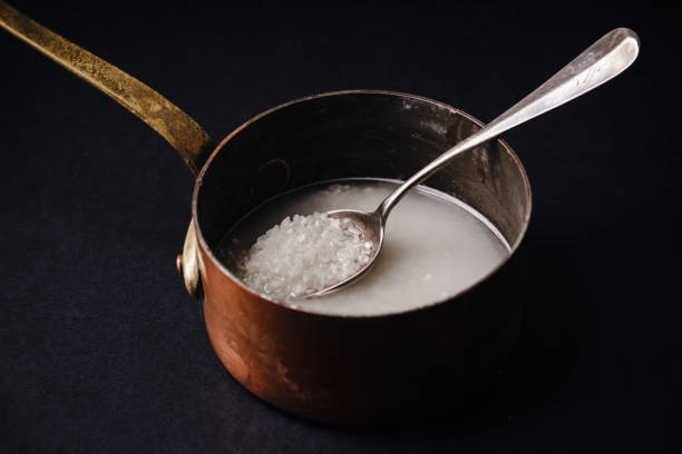 istock Rinsing arborio rice in copper saucepan 1075663180