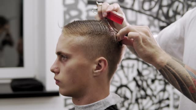 Haircutter making male hair cut with hair clipper and comb in hairdressing  salon close up. Hairdresser doing professional hairstyle with electric  shaver Free Stock Video Footage Download Clips electric razor