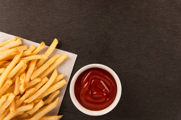 istock French fries with ketchup on dark background 1075670764