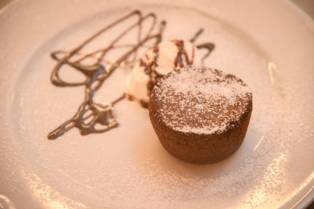 istock Chocolate muffins with chocolate syrup and ice cream . 1075672618