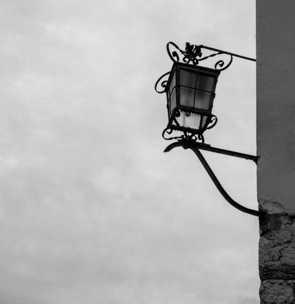 istock Old lantern on the wall with background on the sky 1075680952