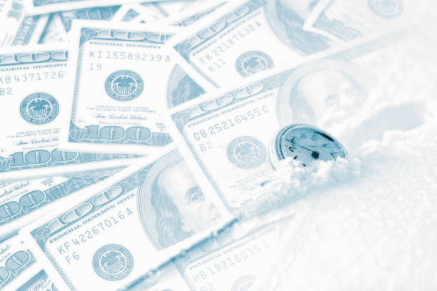 istock Pocketwatch in Snow with US Currency 1075681566