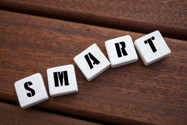 istock SMART Concept with alphabet blocks on wooden table. 1075683568