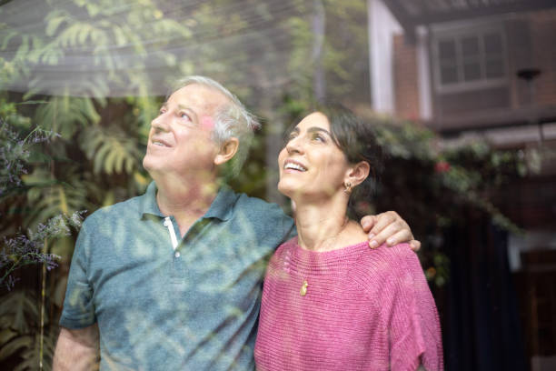 istock Senior Couple Looking Through Window 1075688398