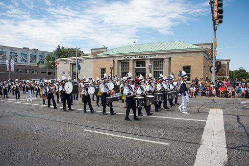Naperville, Illinois, United States-May 29,2017: Neuqua Valley High School marching band performing during the Memorial Day parade with crowds in Naperville, Illinois