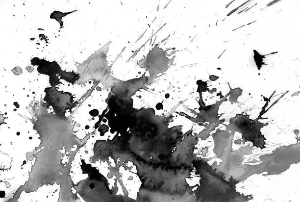 Black watercolor abstract with splashes on white watercolor paper. My own work.