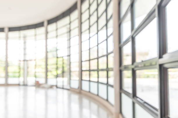Blur background interior view looking out toward to empty office lobby and entrance doors and glass curtain wall