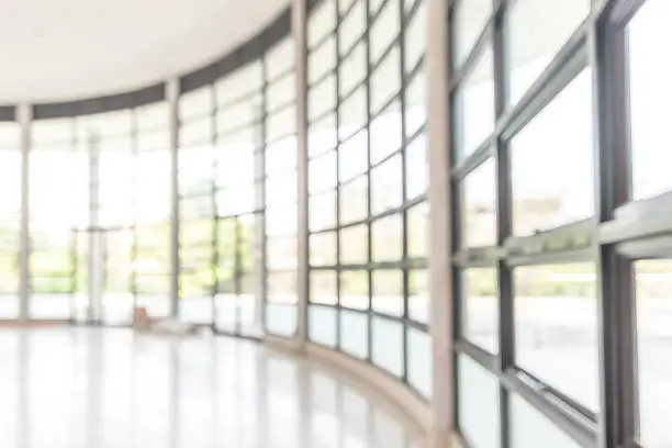 Photo of Blur background interior view looking out toward to empty office lobby and entrance doors and glass curtain wall