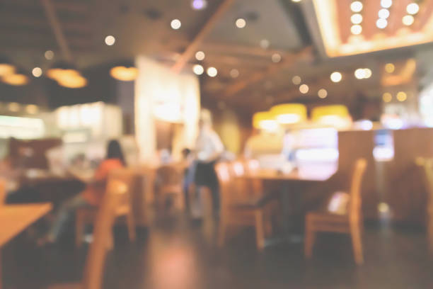 istock Restaurant interior with customer and wood table blur abstract background with bokeh light 1075733644