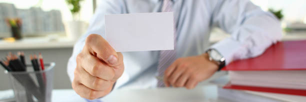 istock Male arm in suit give blank calling card 1075734162