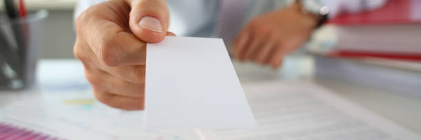 istock Male arm in suit give blank calling card 1075734164