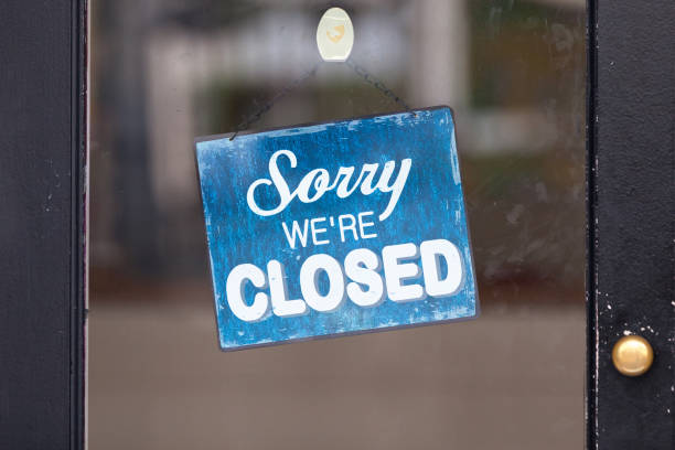 Sorry, we're closed Close-up on a closed sign in the window. closed sign stock pictures, royalty-free photos & images