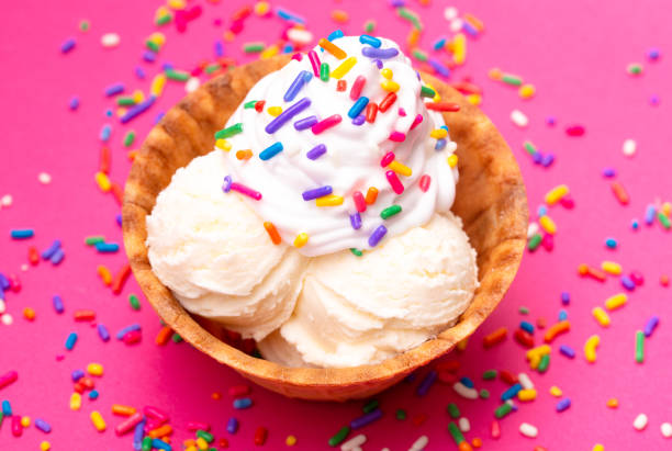istock Vanilla Ice Cream in a Waffle Cone Bowl on a Pink Background 1075750794