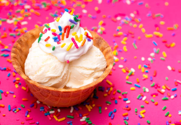 istock Vanilla Ice Cream in a Waffle Cone Bowl on a Pink Background 1075750974