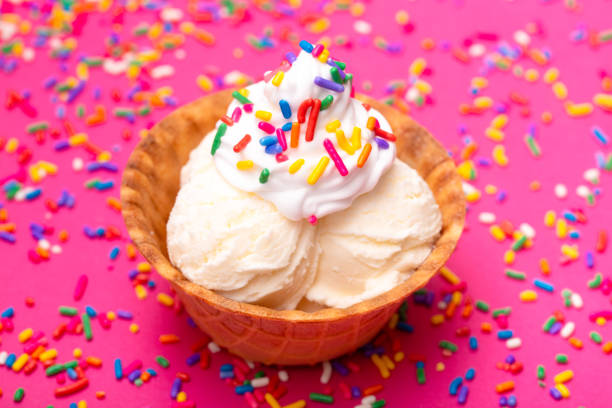istock Vanilla Ice Cream in a Waffle Cone Bowl on a Pink Background 1075750978