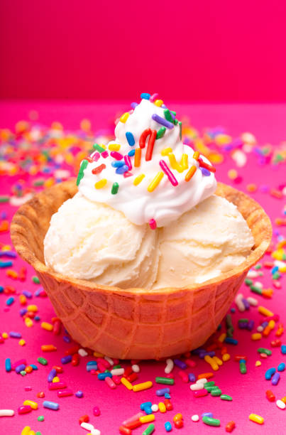 istock Vanilla Ice Cream in a Waffle Cone Bowl on a Pink Background 1075752282