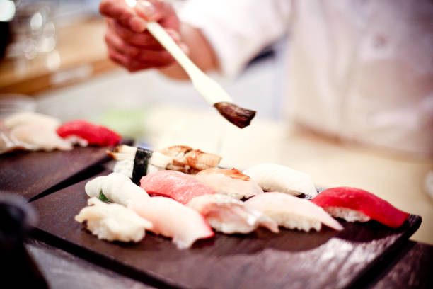 istock Japanese chef preparing a sushi platter at a seafood bar 1075763942