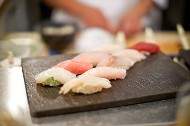 istock Japanese chef preparing a sushi platter at a seafood bar 1075764110