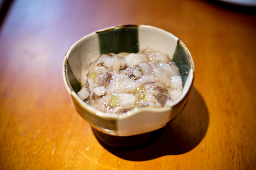 Sannakji Japanese raw octopus appetizer. specialty cuisine dish at a restaurant.  Fresh raw seafood octopus delicacy.