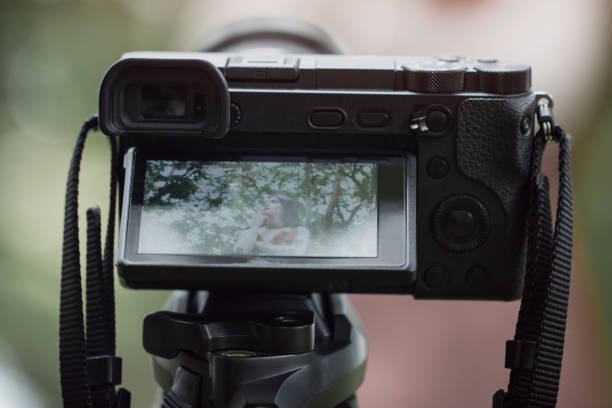 istock asian beauty vlogger review smartphone tutorial vlog viralclip on live streaming and behind cameraman Video or professional digital mirrorless on tripod for camera recording at outdoor 1075792422