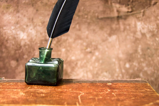 istock Old inkwell and quill pen. Vintage background. Free space for text. 1075794130