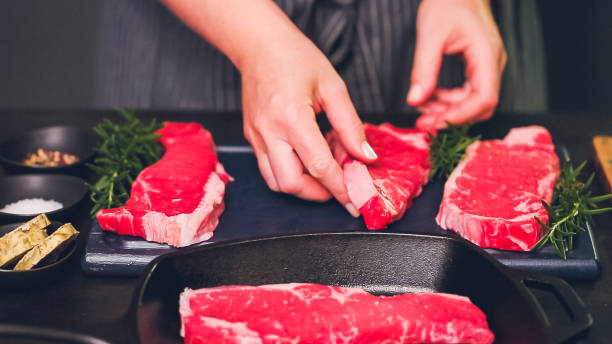 istock Raw New York strip steaks in cast iron frying pan. 1075794182