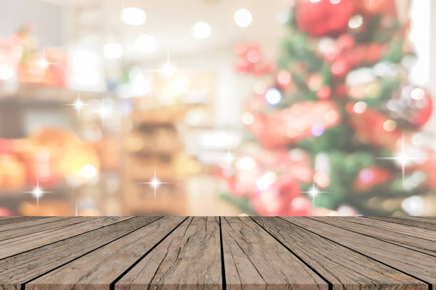 istock abstract blurry beautiful of decoration Christmas tree with blink snowfall and star shape  on background and plank wooden texture floor for show,advertise,promote product concept 1075802382