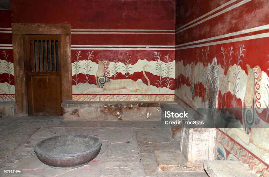Knossos Throne Room The Minoan alabaster throne is surrounded by beautiful murals in Knossos, Crete, Greece. Knossos Stock Photo