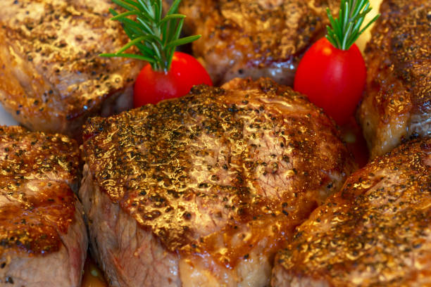 Steak dinner Orgnic tri tip steak freshly cooked and garnished with rosemary and cherry tomatoes grass fed stock pictures, royalty-free photos & images