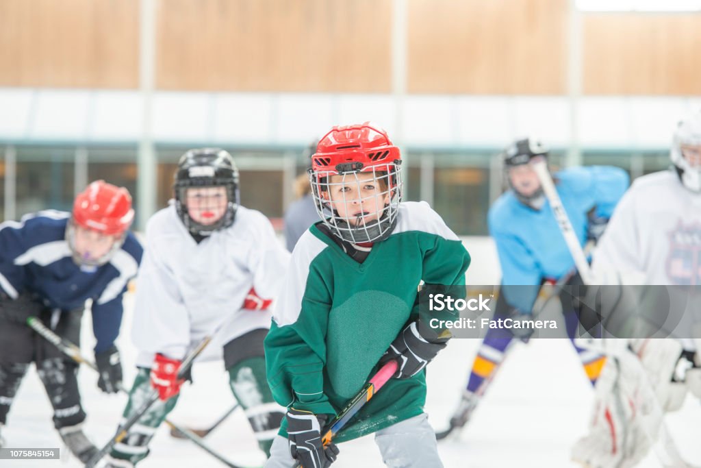 Kids Playing Hockey Together Stock Photo - Download Image Now - Child